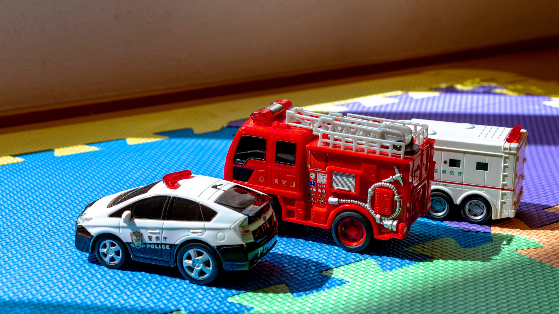 Photo of three civic vehicles, cop car, firetruck, and ambulance