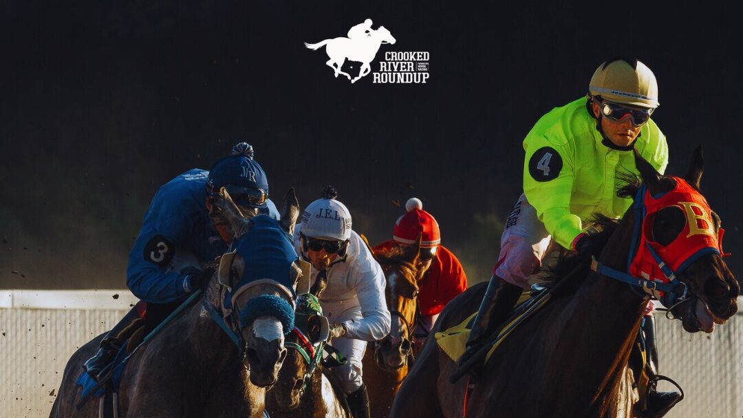 Four jockeys racing horses at the Crooked River Roundup