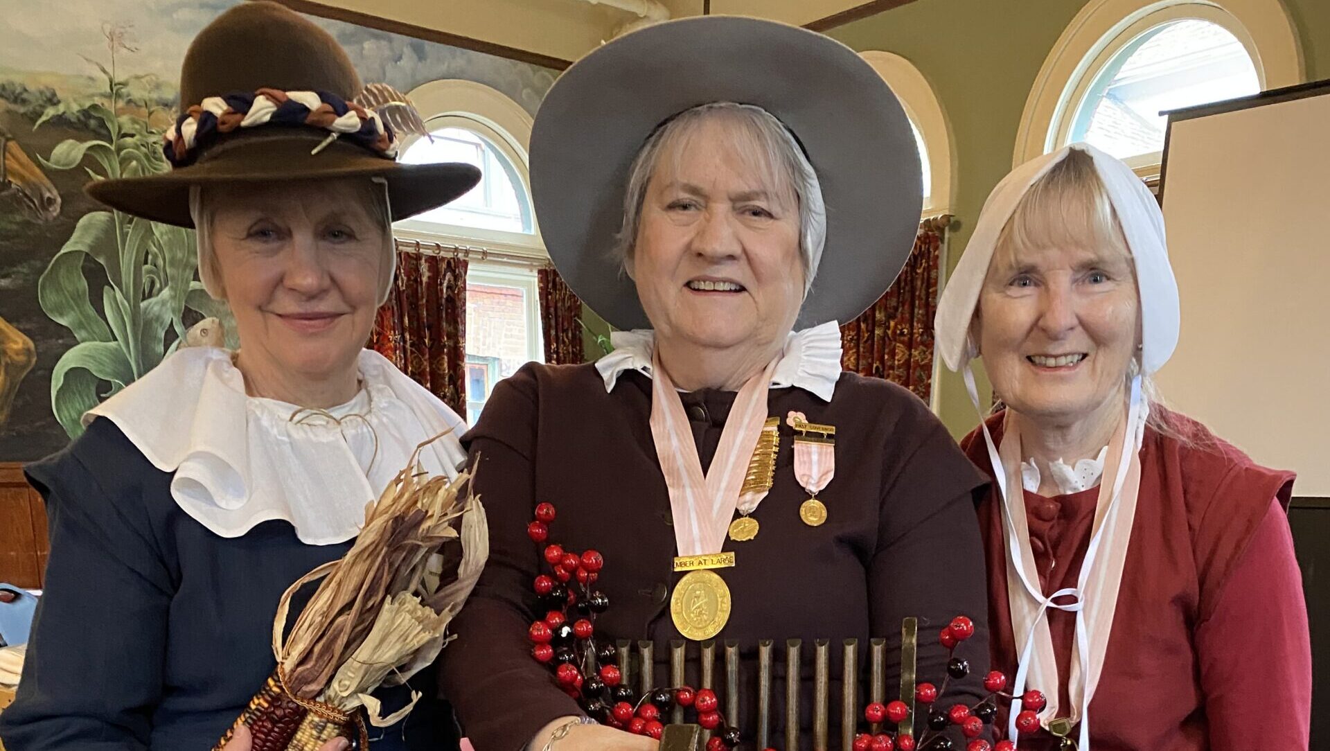 Three women dressed up in pioneer garb