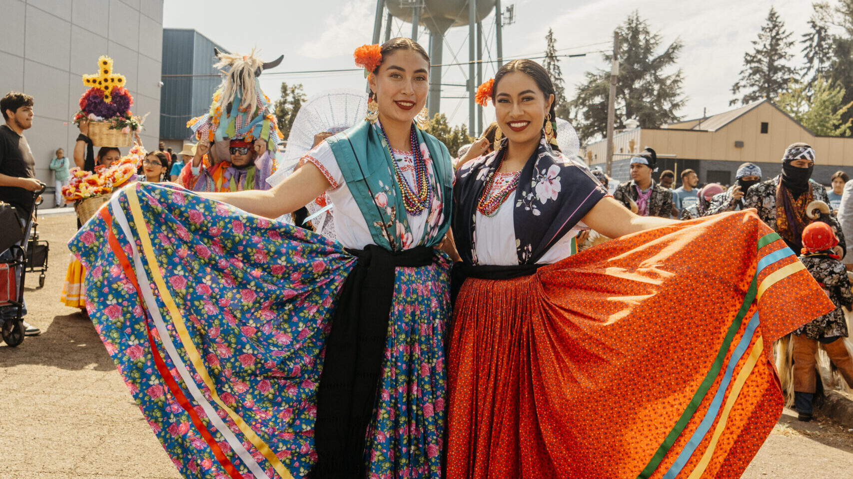Two traditional dancers posing with their dresses